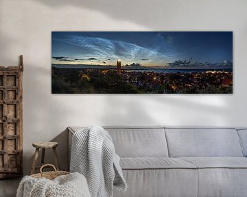 Panorama met lichtende nachtwolken boven West-Terschelling