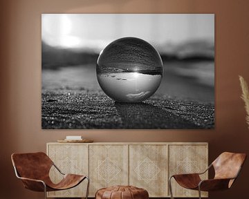 View through the glass ball on the beach. Sea and sky in the background. by Martin Köbsch