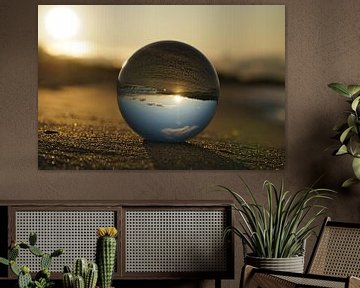 View through the glass ball on the beach. Sea and sky in the background. by Martin Köbsch