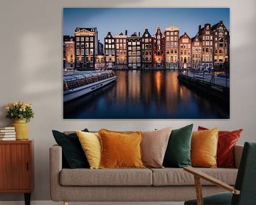 Canal houses on the Damrak in Amsterdam during the blue hour by Thea.Photo