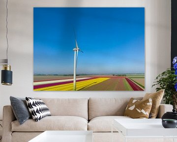 Wind turbine in front of tulips growing in agricultural fields s by Sjoerd van der Wal