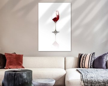 Red wine sloshes in wine glass by Thomas Prechtl