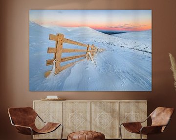 Wooden fence on top of a snowy mountain by Martijn Smeets