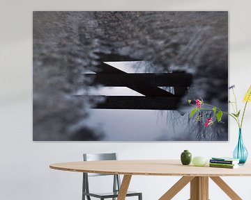 Reflection of fence in puddle by Renske van Lierop