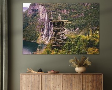 Stone hut in front of waterfall by Thomas Heitz