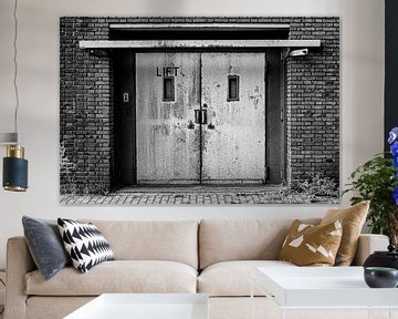 Old elevator in the facade of a factory hall by shoott photography