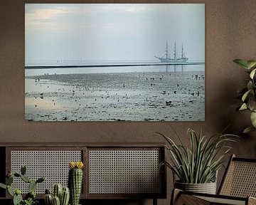 Sailing vessel on dry mudflats by Frank Mossink