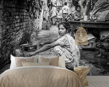 Girl does laundry in slum of Varanasi in India by Wout Kok