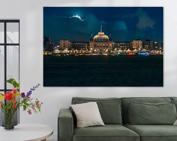 Kurhaus Scheveningen during blue hour with the moon slowly emerging through the clouds by Jolanda Aalbers