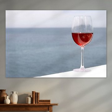 Glass with pink wine, sea in background