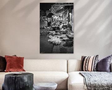 Man waits for customers at his booth by Bart van Lier