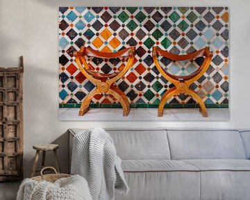 Two authentic chairs in front of a mosaic wall by Ben De Kock