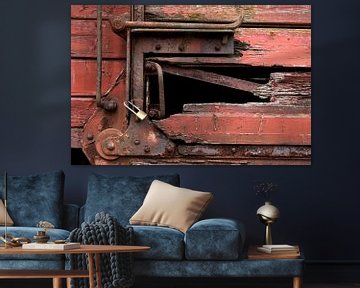 closeup of a train car with a lock and rotten wood