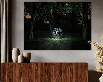 Luminous spherical shape in the forest (lightpainting)