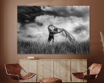 Dancing woman in beach grass on a cloudy day by Corine de Ruiter