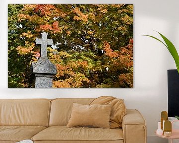 A cross in a cemetery in autumn by Claude Laprise