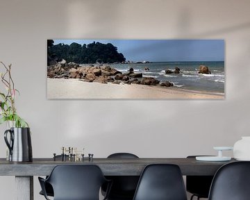Panorama photo of a sunny sandy beach with many stones by Maurice de vries