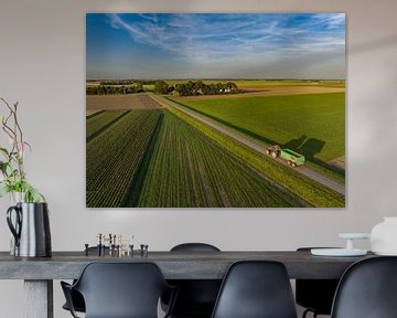 Tractor hauling a trailer driving on a country road during sunset by Sjoerd van der Wal Photography