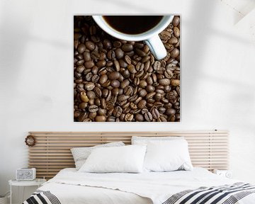 freshly roasted coffee beans and a cup of coffee on a kitchen table by Heiko Kueverling