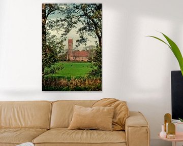 Church Midwolde in a frame with tree branches in portrait position