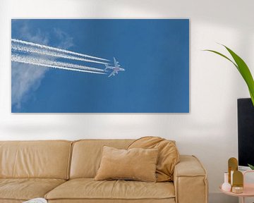 Emirates A380 draws condensation streaks high in the sky. by Jaap van den Berg
