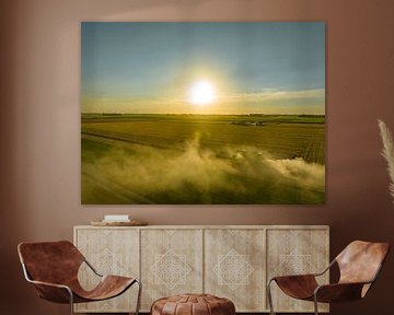 Combine harverster harvesting wheat during summer seen from abo by Sjoerd van der Wal Photography