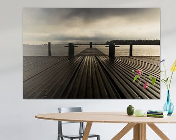 Dock in black and white with a threatening cloud sky by Arjan van der Veer