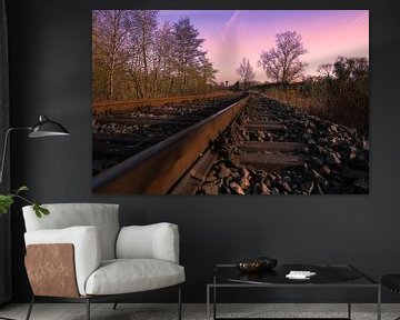 Railway line under purple sunset sky by Raphotography