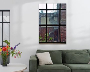 Factory window view with spiral staircase