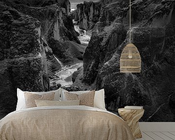Canyon gorge with river course on Iceland in black and white .