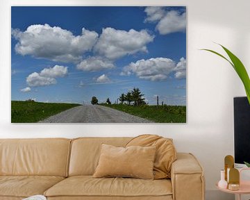 A country road under blue skies by Claude Laprise