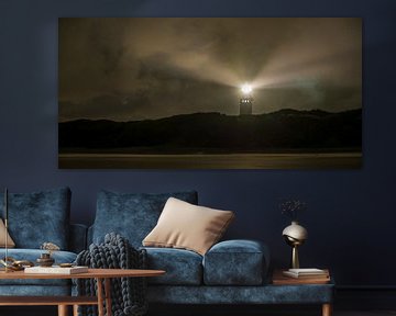 Lighthouse in the dunes with lightbeams at night by Sjoerd van der Wal Photography