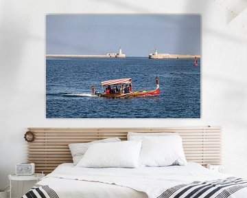 tourist boat with lighthouses in the background