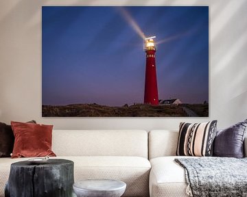 Lighthouse at Schiermonnikoog island in the dunes during sunset
