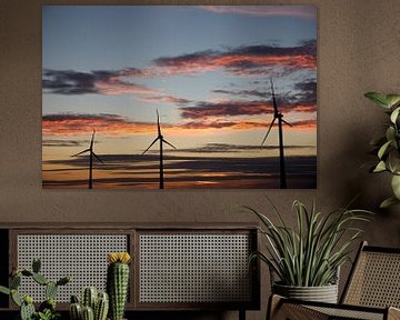 sunset with three wind turbines forming part of a wind farm by W J Kok