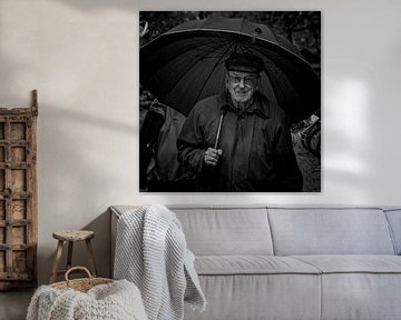 Man with umbrella at market by Ton Van Zeijl