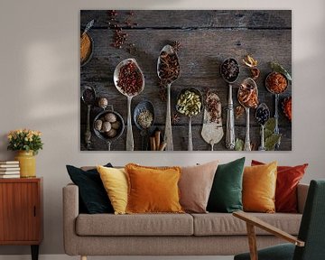 Spices on an old wooden table table by Saskia Schepers