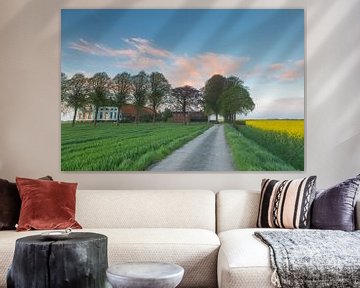 Sunset near a rapeseed field and a borg by Hillebrand Breuker