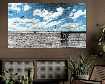 Woman and girls in wetsuits running on the beach by John Duurkoop