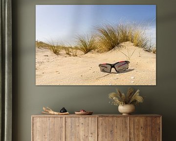 The lost sunglasses on the deserted beach by John Duurkoop
