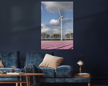 a modern wind turbine and a pink tulip field provides green energy