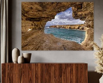 Cave with a view of the rocky coast by Dennis Eckert