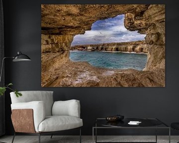 Cave with a view of the rocky coast by Dennis Eckert