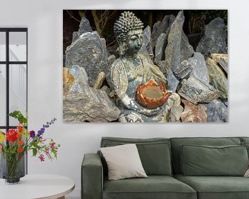 Buddha figure in rock garden background by Animaflora PicsStock