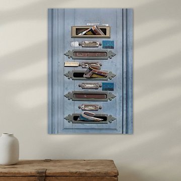 French mailboxes with mail in an old blue door by Birgitte Bergman