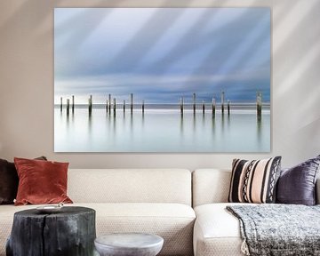 Serene coastal landscape with poles by Bas Ruiter