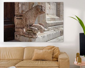 Lion in front of the door of San Rufino cathedral in Assisi, Italy by Joost Adriaanse