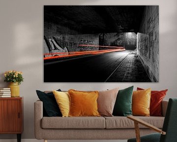 Light trails from a car in a tunnel by Jeroen Berendse