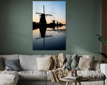 Silhouette of windmills by the water by Erwin Pilon