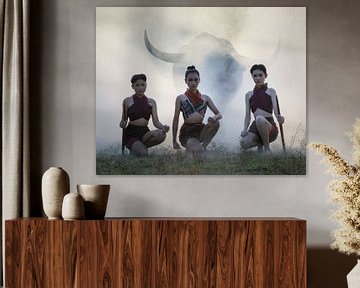 Three young Thai women with a water buffalo